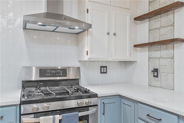 7824 Terrace St, Kansas City, MO 64114 - kitchen featuring stainless steel range with gas cooktop, wall chimney exhaust hood, open shelves, tasteful backsplash, and light countertops