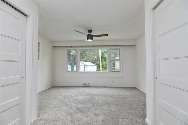 7824 Terrace St, Kansas City, MO 64114 - carpeted empty room with ceiling fan