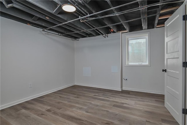 7824 Terrace St, Kansas City, MO 64114 - basement featuring baseboards and wood finished floors