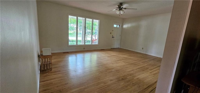 1113 W 27th St, Lawrence, KS 66046 - empty room featuring wood finished floors and ceiling fan