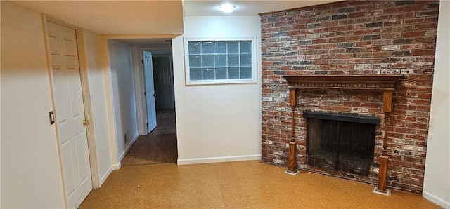 1113 W 27th St, Lawrence, KS 66046 - unfurnished living room with baseboards and a brick fireplace