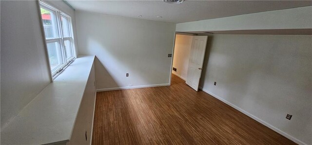 1113 W 27th St, Lawrence, KS 66046 - unfurnished room featuring baseboards and wood finished floors
