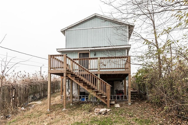 4429 Wabash Ave, Kansas City, MO 64130 - rear view of house with a wooden deck and stairway