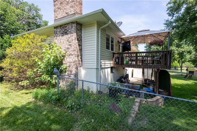 2905 Ajax Rd, Saint Joseph, MO 64503 - view of home's exterior with a chimney, a gazebo, a wooden deck, and stairway