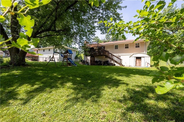 2905 Ajax Rd, Saint Joseph, MO 64503 - fenced backyard featuring stairway, a playground, a storage shed, and a wooden deck