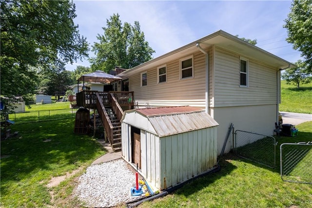 2905 Ajax Rd, Saint Joseph, MO 64503 - rear view of property with a wooden deck, stairs, and an outdoor structure
