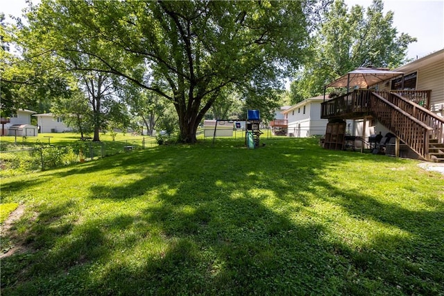 2905 Ajax Rd, Saint Joseph, MO 64503 - fenced backyard with stairs, a playground, a gazebo, and a deck