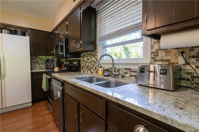 2905 Ajax Rd, Saint Joseph, MO 64503 - kitchen featuring freestanding refrigerator, range with electric stovetop, dishwasher, dark brown cabinetry, and backsplash