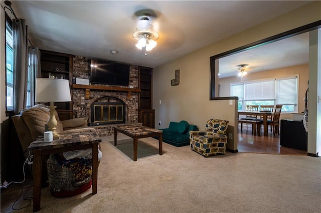 2905 Ajax Rd, Saint Joseph, MO 64503 - living room featuring a ceiling fan, built in features, carpet floors, and a fireplace
