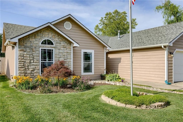 506 12th Ter, Tonganoxie, KS 66086 - view of front of home with stone siding, a shingled roof, a front yard, and a garage