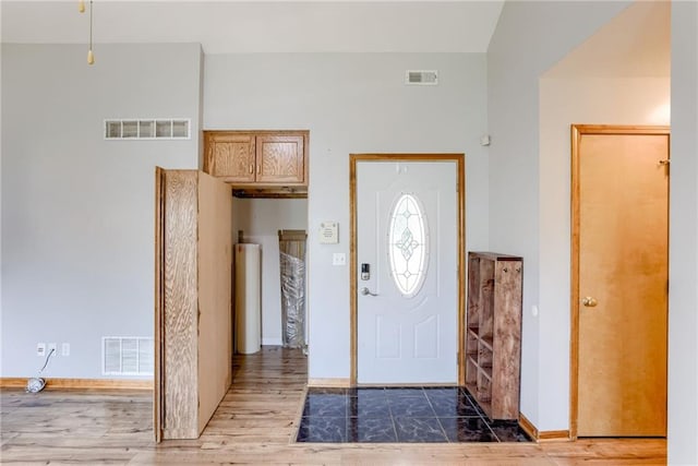 506 12th Ter, Tonganoxie, KS 66086 - foyer featuring wood finished floors and baseboards