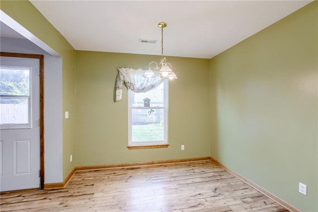 506 12th Ter, Tonganoxie, KS 66086 - unfurnished dining area featuring a chandelier and light wood-style flooring