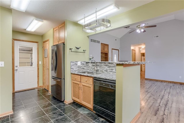 506 12th Ter, Tonganoxie, KS 66086 - kitchen with black dishwasher, freestanding refrigerator, a peninsula, ceiling fan, and light stone countertops