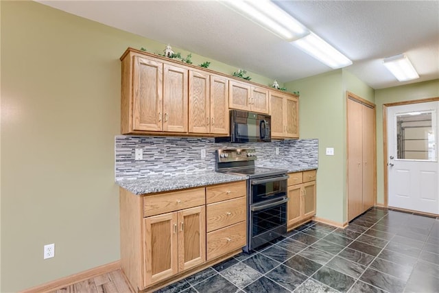 506 12th Ter, Tonganoxie, KS 66086 - kitchen with black microwave, range with two ovens, backsplash, a textured ceiling, and light brown cabinetry
