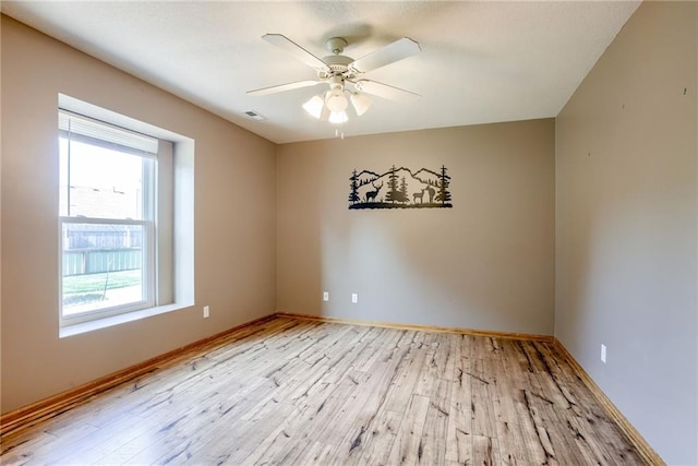 506 12th Ter, Tonganoxie, KS 66086 - unfurnished room featuring wood finished floors and ceiling fan