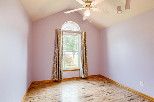 506 12th Ter, Tonganoxie, KS 66086 - spare room featuring wood finished floors, a ceiling fan, and vaulted ceiling