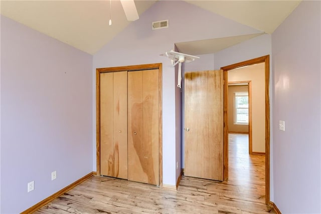 506 12th Ter, Tonganoxie, KS 66086 - unfurnished bedroom featuring light wood finished floors, a closet, and high vaulted ceiling