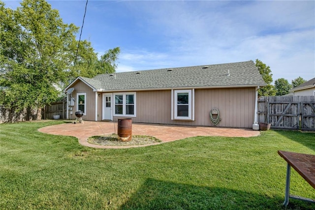 506 12th Ter, Tonganoxie, KS 66086 - back of property featuring a patio, a fenced backyard, and a shingled roof