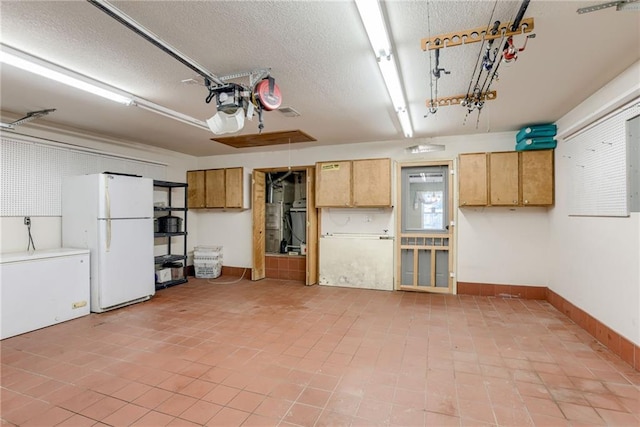 506 12th Ter, Tonganoxie, KS 66086 - garage featuring freestanding refrigerator and fridge