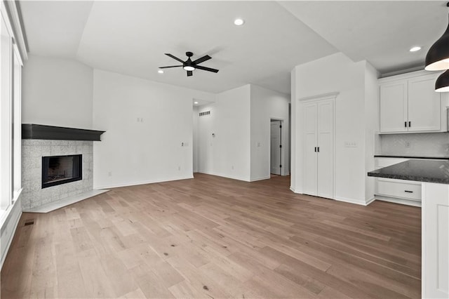 20015 W 221st St, Spring Hill, KS 66083 - unfurnished living room featuring a ceiling fan, light wood finished floors, recessed lighting, and a tile fireplace