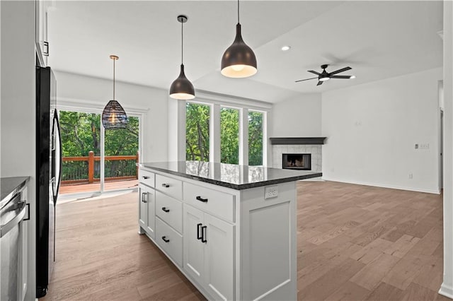 20015 W 221st St, Spring Hill, KS 66083 - kitchen with a ceiling fan, black fridge, plenty of natural light, a fireplace with raised hearth, and recessed lighting
