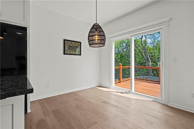 20015 W 221st St, Spring Hill, KS 66083 - unfurnished dining area with wood finished floors and baseboards
