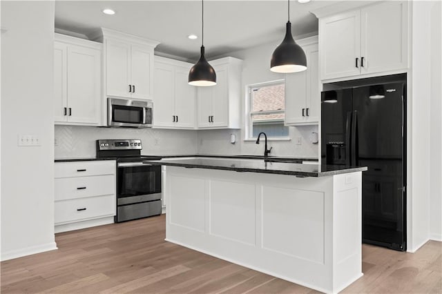 20015 W 221st St, Spring Hill, KS 66083 - kitchen with stainless steel appliances, light wood-style floors, white cabinets, recessed lighting, and a kitchen island with sink