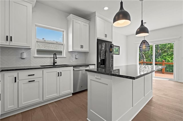 20015 W 221st St, Spring Hill, KS 66083 - kitchen with stainless steel dishwasher, black fridge, wood finished floors, white cabinetry, and recessed lighting