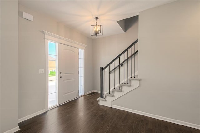 6110 NE 118th St, Kansas City, MO 64156 - foyer with a chandelier, dark wood-style flooring, and stairs