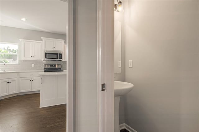 6110 NE 118th St, Kansas City, MO 64156 - bathroom featuring wood finished floors and decorative backsplash