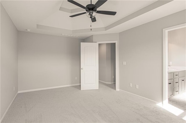 6110 NE 118th St, Kansas City, MO 64156 - unfurnished bedroom featuring a raised ceiling, light colored carpet, connected bathroom, and a ceiling fan