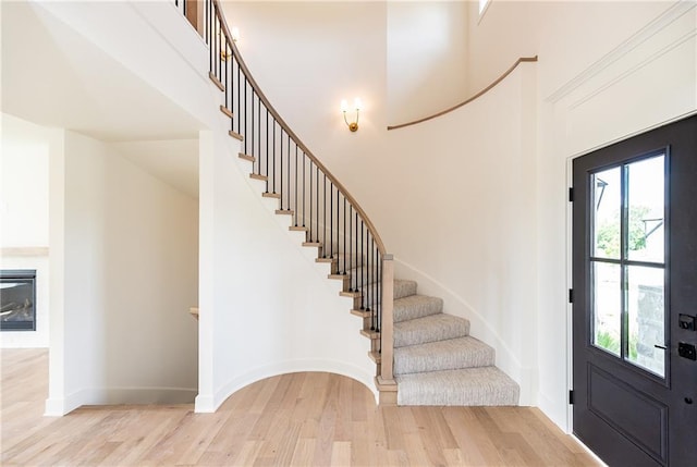 18505 Mohawk Ln, Overland Park, KS 66085 - entrance foyer featuring wood finished floors, stairs, and a high ceiling