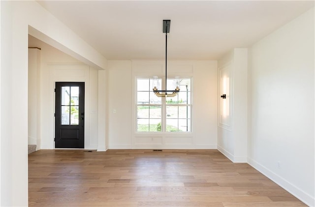18505 Mohawk Ln, Overland Park, KS 66085 - foyer with light wood-style flooring, a chandelier, and healthy amount of natural light