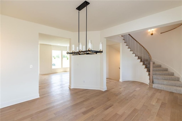 18505 Mohawk Ln, Overland Park, KS 66085 - unfurnished room featuring a chandelier, light wood-style flooring, and stairway