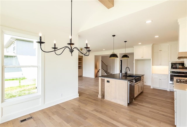 18505 Mohawk Ln, Overland Park, KS 66085 - kitchen featuring appliances with stainless steel finishes, a chandelier, light wood-type flooring, recessed lighting, and white cabinets