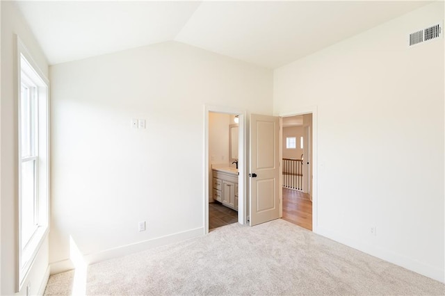 18505 Mohawk Ln, Overland Park, KS 66085 - unfurnished bedroom with carpet flooring, lofted ceiling, and connected bathroom