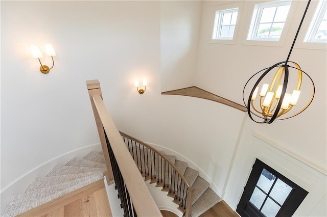 18505 Mohawk Ln, Overland Park, KS 66085 - stairs featuring plenty of natural light and a chandelier