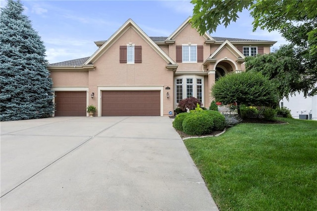 5716 W 146th St, Overland Park, KS 66223 - traditional-style house with a front yard, a garage, stucco siding, and concrete driveway