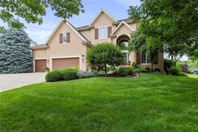 5716 W 146th St, Overland Park, KS 66223 - view of front of home with an attached garage, stucco siding, a front yard, and concrete driveway
