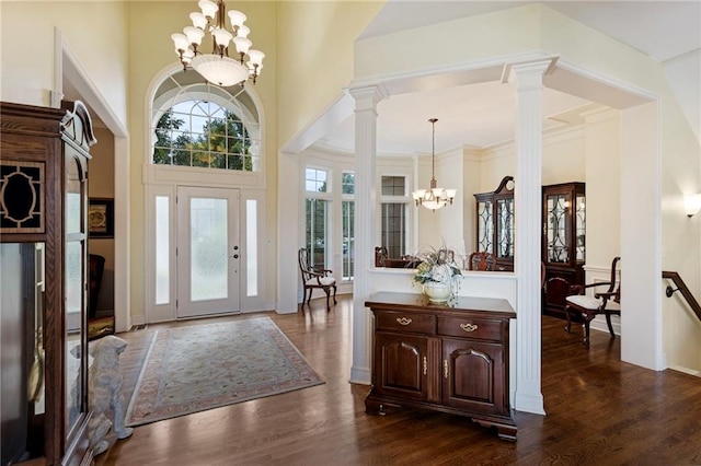 5716 W 146th St, Overland Park, KS 66223 - foyer entrance featuring a chandelier, dark wood finished floors, ornate columns, and a high ceiling