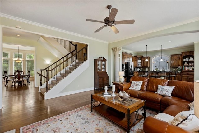 5716 W 146th St, Overland Park, KS 66223 - living area featuring wood finished floors, stairs, crown molding, a ceiling fan, and a chandelier