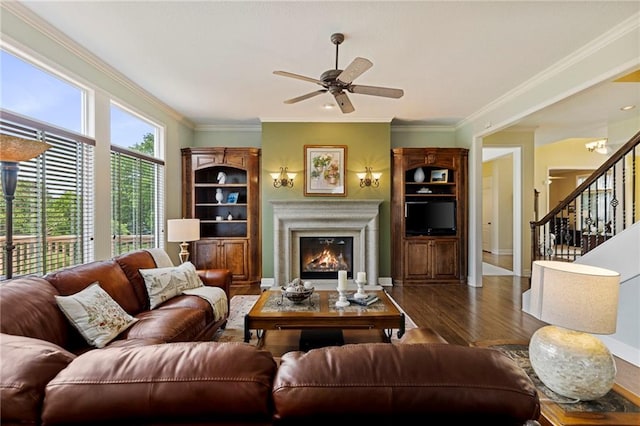 5716 W 146th St, Overland Park, KS 66223 - living room with ceiling fan, wood finished floors, a glass covered fireplace, crown molding, and stairs