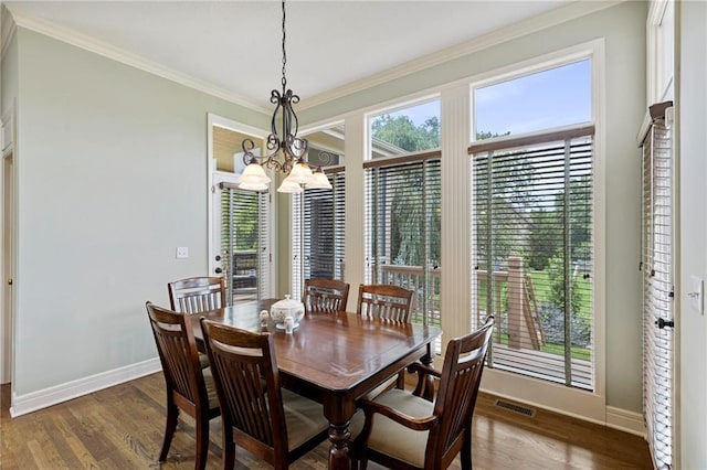 5716 W 146th St, Overland Park, KS 66223 - dining area with a chandelier, wood finished floors, and crown molding