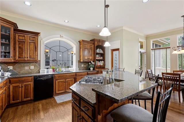 5716 W 146th St, Overland Park, KS 66223 - kitchen featuring dishwasher, stainless steel gas stovetop, a breakfast bar area, a chandelier, and a kitchen island