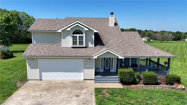 198 SE 455th Rd, Warrensburg, MO 64093 - view of front of property with a porch, concrete driveway, a front lawn, and a garage