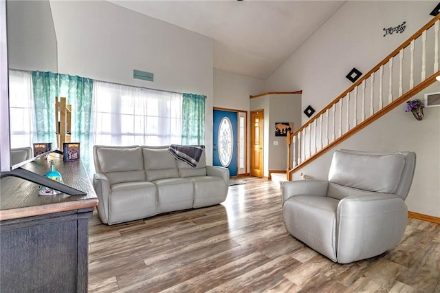 198 SE 455th Rd, Warrensburg, MO 64093 - living area with wood finished floors, stairway, and high vaulted ceiling