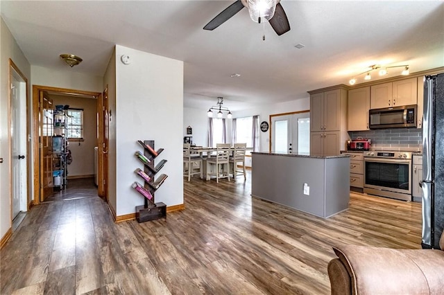 198 SE 455th Rd, Warrensburg, MO 64093 - kitchen with appliances with stainless steel finishes, a ceiling fan, tasteful backsplash, wood finished floors, and plenty of natural light