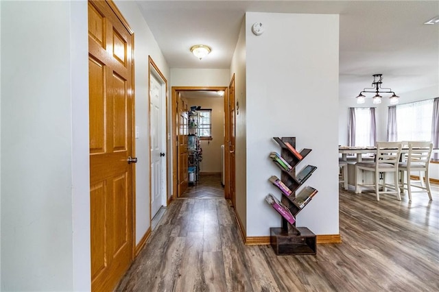 198 SE 455th Rd, Warrensburg, MO 64093 - hallway featuring wood finished floors and a chandelier
