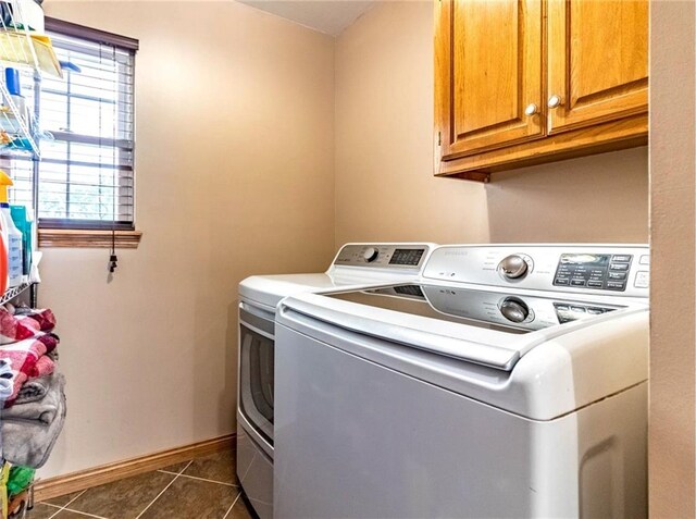 198 SE 455th Rd, Warrensburg, MO 64093 - washroom with cabinet space, washing machine and clothes dryer, and dark tile patterned floors