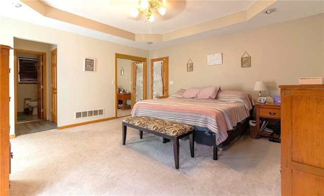 198 SE 455th Rd, Warrensburg, MO 64093 - bedroom with light colored carpet, a tray ceiling, and a ceiling fan